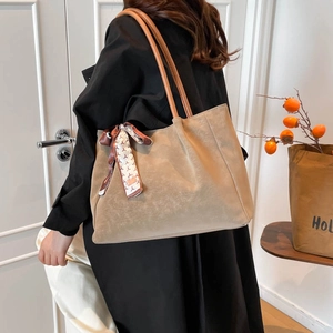 Large khaki suede tote bag with brown leather straps and patterned silk scarf detail
