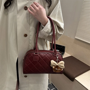Burgundy quilted shoulder bag with plush bear charm and matching long handle strap