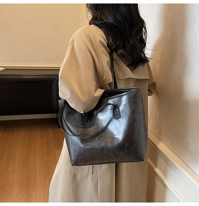 Detail of vintage large leather tote bag with FASHION & BAG LEATHER print on model