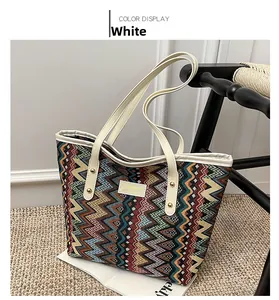 Detail of bohemian tote bag featuring colorful zigzag patterns and cream leather accents
