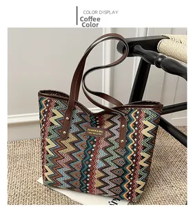 Detail of coffee brown bohemian woven tote bag with leather straps on a rustic jute rug