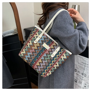 Detail of colorful woven canvas crossbody bag with retro stripes and leather strap