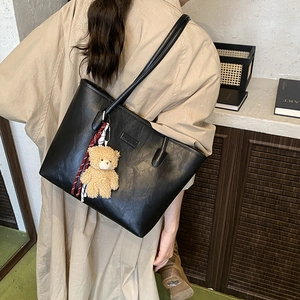 Minimalist black faux leather tote bag with large capacity and cute bear keychain
