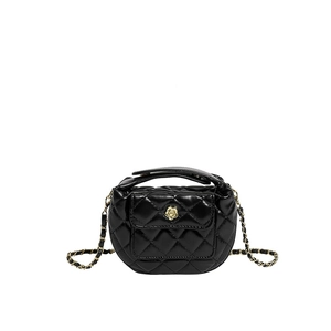 Chic black quilted mini crossbody bag with golden flower clasp and chain strap