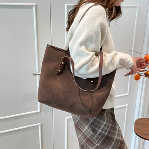 Large brown suede tote bag with rivets and shoulder straps for autumn winter style