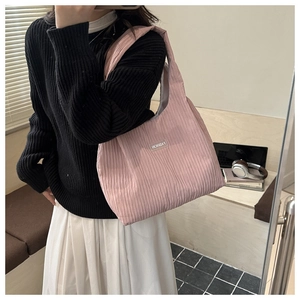 Detail of pink pleated canvas tote bag showing fashion tag and crinkle texture