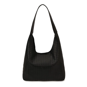 Large black woven leather tote bag with wide shoulder strap in a minimalist style