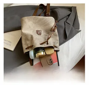 Detail of vintage suede backpack interior showing capacity for tablet and cosmetics
