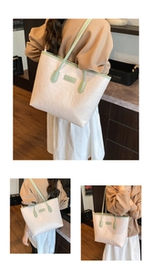 Detail of large tote bag featuring embossed graffiti heart patterns and green straps