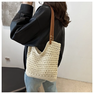 Close-up of handmade woven tote bag showing net texture and brown leather straps