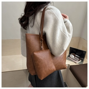 Caramel tote bag detail featuring large shoulder bag and small matching pouch with knot