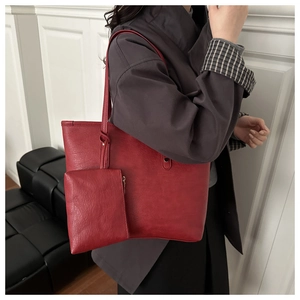 Detail of red large tote bag with matte leather texture and detachable small pouch