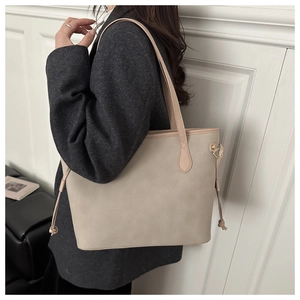 Detail of minimalist beige tote bag with suede texture and side drawstring feature