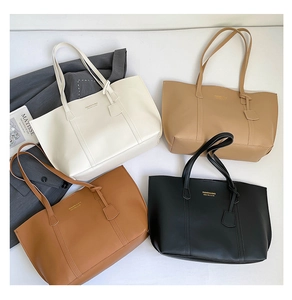 Detailed display of four large capacity tote bags in cream, beige, brown, and black