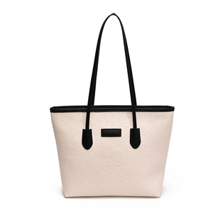 Large cream tote bag with embossed lettering and black handles for women's daily commute