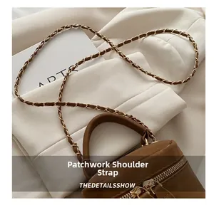 Close-up of brown leather mini box bag with chain strap and double metal zippers