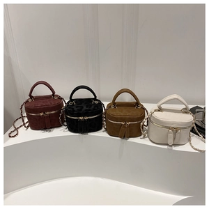 Detailed row of mini leopard vanity bags with gold chain straps in four trendy colors