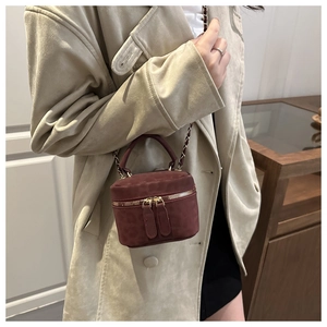 Detail of burgundy leopard print mini bag with gold chain strap and top handle