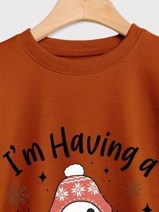 Detail of rust red crewneck sweatshirt with I'm Having a holiday print and ribbed collar