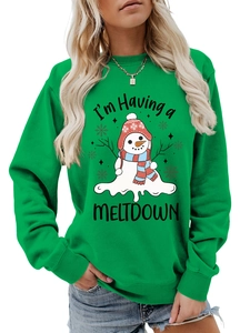 Detail of the melted snowman print and 'I'm Having a MELTDOWN' text on green sweatshirt