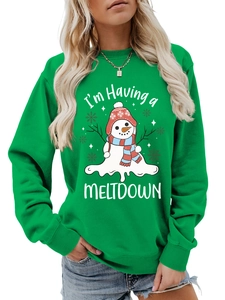 Close-up of green crewneck sweatshirt featuring a melting snowman and holiday slogan