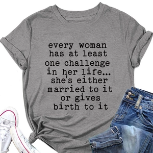 Flat lay of gray cotton T-shirt with black typewriter quote print and blue ripped jeans