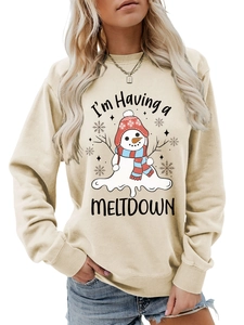 Detail of melting snowman graphic and 'I'm Having a MELTDOWN' text on beige sweatshirt