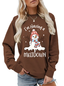 Close-up of brown crewneck sweatshirt featuring a melting snowman with Meltdown text print