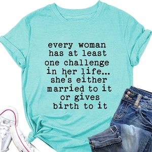 Flat lay of women's turquoise t-shirt with black graphic text print and casual jeans