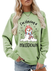 Detail of light green sweatshirt with melting snowman print and funny graphic text