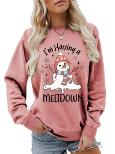 Detail of melting snowman print and funny Meltdown slogan on pink sweatshirt