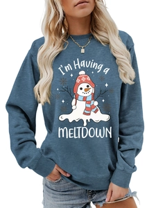 Close-up of I'm Having a MELTDOWN melting snowman print on blue crewneck sweatshirt