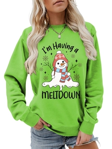 Close-up of bright green sweatshirt featuring a funny melting snowman graphic print