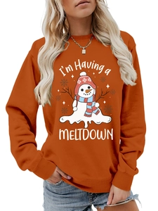 Detail view of the I'm Having a Meltdown melting snowman print on orange sweatshirt
