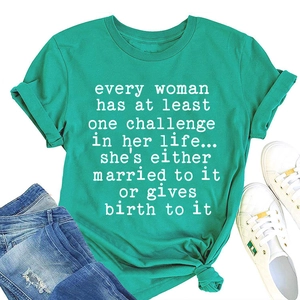 Detail of green cotton T-shirt featuring white slogan print and stylish knotted hem design