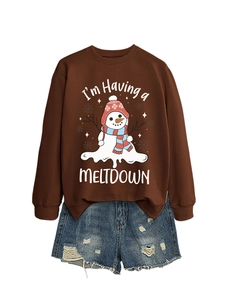 Close-up of melting snowman graphic and slogan on brown long sleeve crewneck sweatshirt