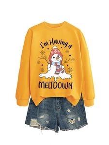 Close-up of bright yellow sweatshirt with a melting snowman graphic and blue denim shorts