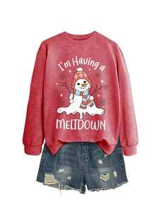 Detailed flat lay of red crewneck sweatshirt with melting snowman print and denim shorts