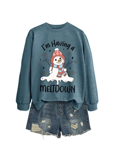 Detail of the melting snowman graphic print on a navy blue long sleeve sweatshirt