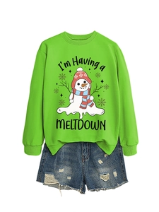 Green sweatshirt with melting snowman print and distressed denim shorts flat lay display