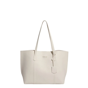 Minimalist beige tote bag with slim shoulder straps and gold fashion branding on white background