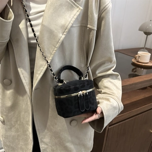 Chic black leopard print suede crossbody bag with gold chain strap worn by model
