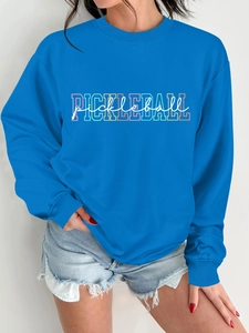 Detail of bright blue Pickleball sweatshirt featuring colorful graphic print and crewneck cut