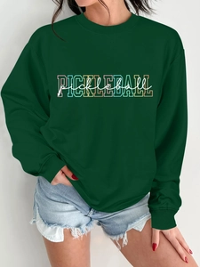 Detail of dark green crewneck sweatshirt with colorful Pickleball print and cotton texture