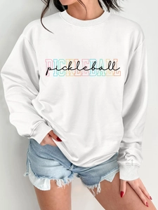Detail of white crewneck sweatshirt featuring rainbow and black Pickleball print