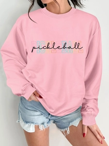 Close-up of pink crewneck sweatshirt featuring a black pickleball script and graphic print