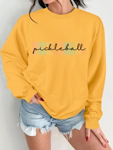 Detail of yellow pickleball crewneck sweatshirt showing soft fabric texture and colorful print