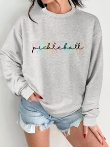 Detail of grey crewneck sweatshirt with colorful Pickleball print and cotton texture