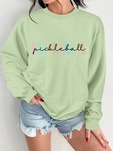 Detail of mint green crewneck sweatshirt featuring a stylish pickleball graphic print