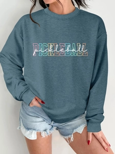 Close-up of the grey-blue crewneck sweatshirt featuring a colorful Pickleball graphic print